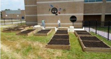  Flower beds in a school yard with soil, waiting for planting.