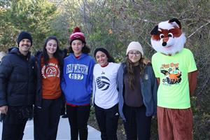 Coach Sellers with former students and Fox Run mascot