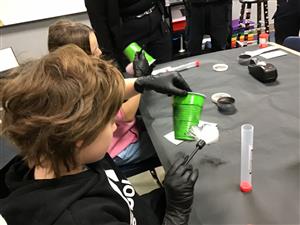 student lifting finger prints