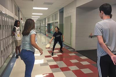 Lee students in hallway playing chinese game 
