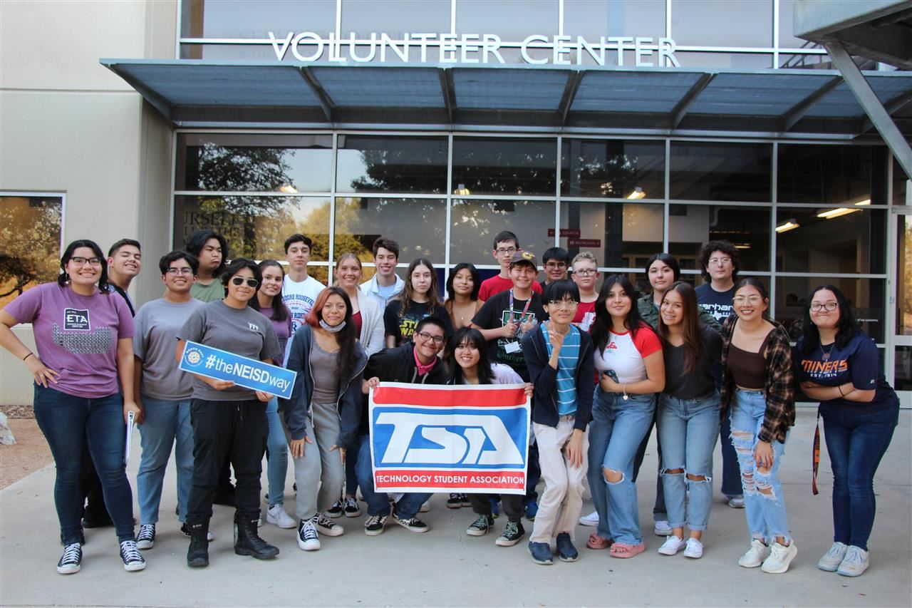 Students pose with a TSA sign outside the SA Food Bank