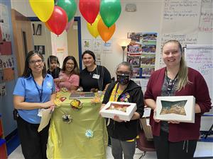 team holding boxes of cookies