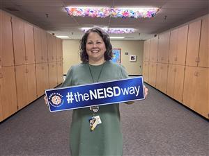 Shawna with NEISD way sign