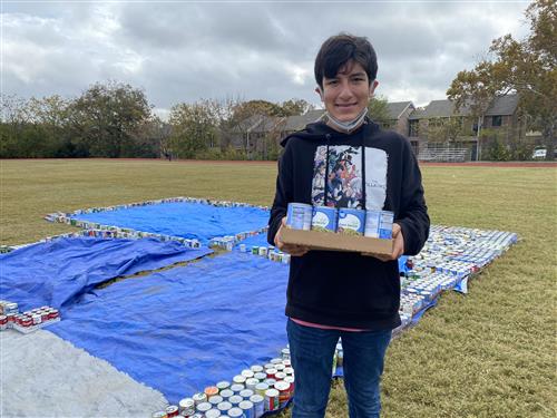 student holding cans