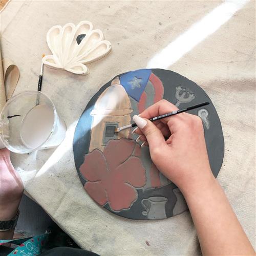 student drawing on clay